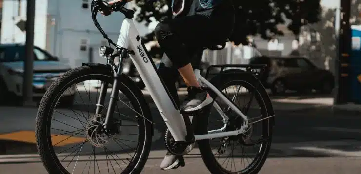 man in black jacket riding on white and black bicycle